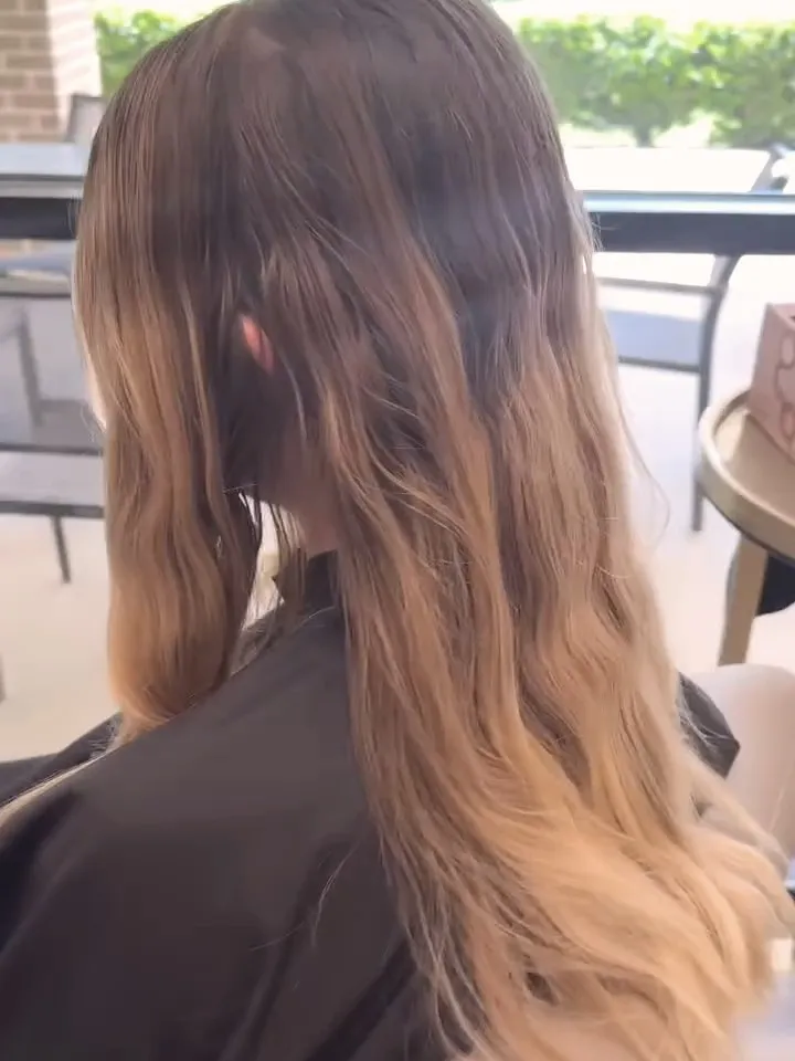 Grown out brassy blonde with dark roots before the color refresh